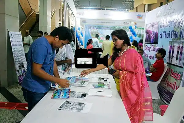 Bangladeshi woman and man at an exhibition booth in a shopping mall. Channel i News - চ্যানেল আই নিউজ