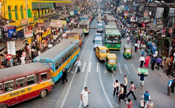 Dhaka city traffic with buses, rickshaws, and pedestrians. Channel i News - চ্যানেল আই নিউজ