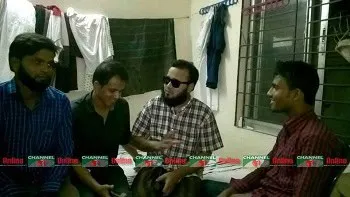 সিদ্দিকুরের ছবি, তিনি sunglasses পরেছেন, পেছনে ঘর ও জানালা দেখা যাচ্ছে. Channel i News - চ্যানেল আই নিউজ