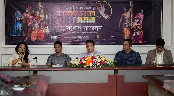 সংবাদ সম্মেলনে অংশগ্রহণকারী ব্যক্তিরা উপস্থিত, পেছনে নৃত্যনাট্য উৎসবের ব্যানার. Channel i News - চ্যানেল আই নিউজ
