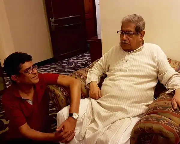 দুই ব্যক্তি একসঙ্গে বসে আলোচনা করছেন, একটি সোফায়।. Channel i News - চ্যানেল আই নিউজ