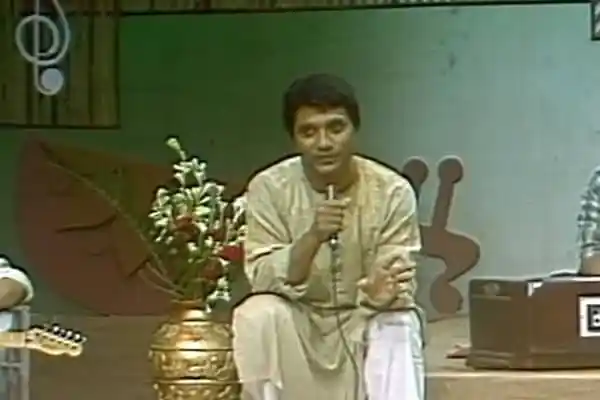আনিসুল হক বক্তৃতা দিচ্ছেন, পটভূমিতে বাংলা সংগীতের নোটেশন. Channel i News - চ্যানেল আই নিউজ