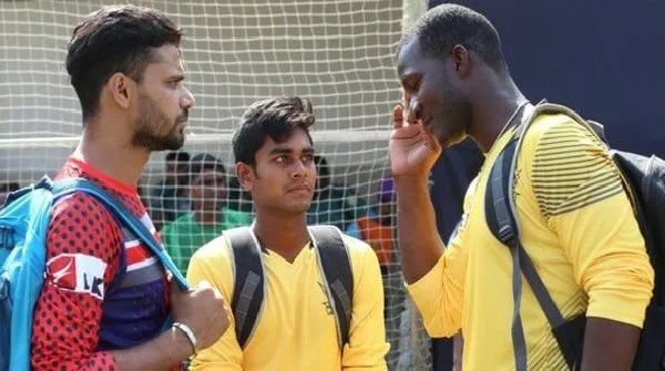 Three young men having a serious conversation outdoors. Channel i News - চ্যানেল আই নিউজ