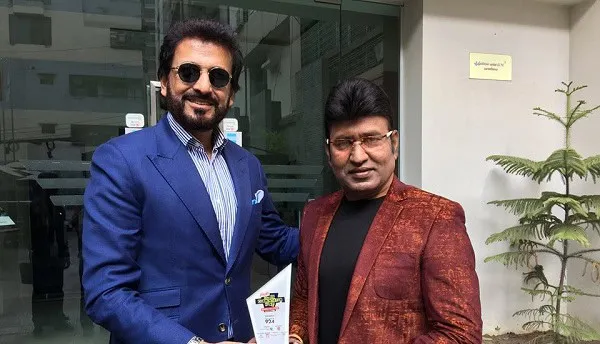 দুই ব্যক্তি হাসিমুখে সাক্ষাৎকারে অংশগ্রহণ করছেন. Channel i News - চ্যানেল আই নিউজ