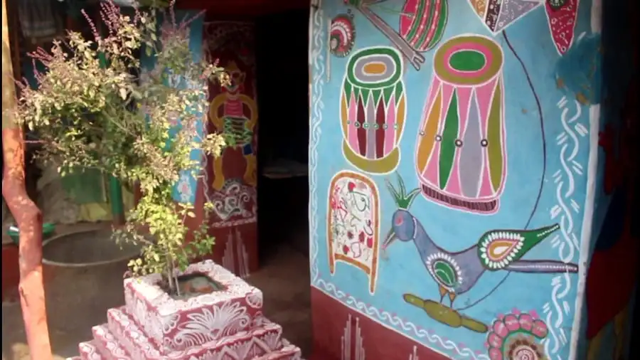 Colorful traditional Bengali wall art and decorations in a rural setting. Channel i News - চ্যানেল আই নিউজ