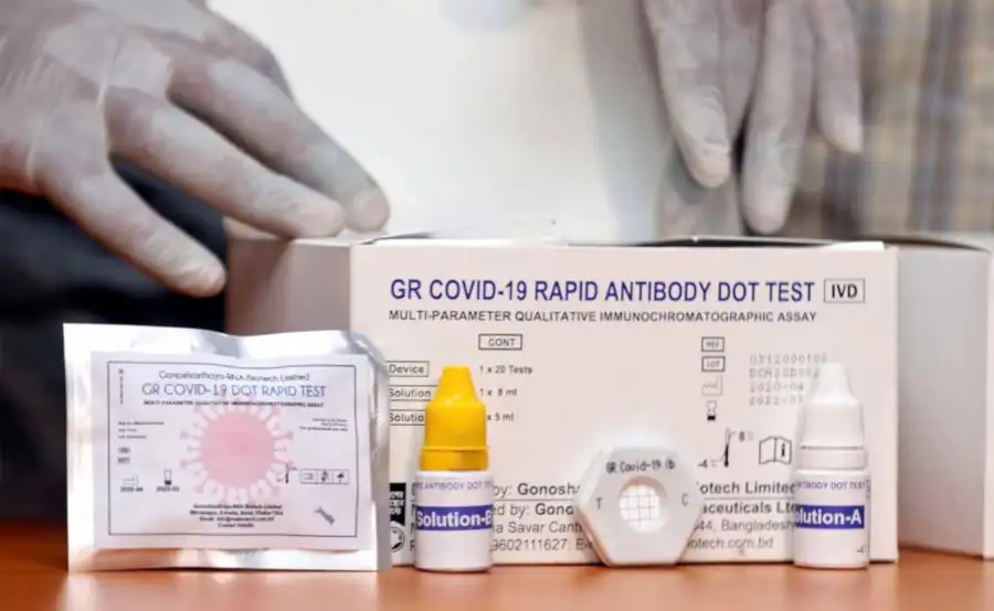 COVID-19 rapid antibody test kit and testing device on table. Channel i News - চ্যানেল আই নিউজ
