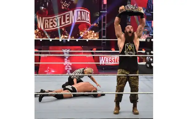 WrestleMania ইভেন্টে একজন রেসলার চ্যাম্পিয়ন ট্রফি হাতে উল্লাস করছে. Channel i News - চ্যানেল আই নিউজ