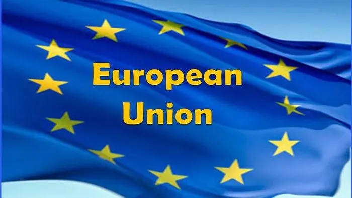 European Union flag with yellow stars and 'European Union' text in Bengali. Channel i News - চ্যানেল আই নিউজ