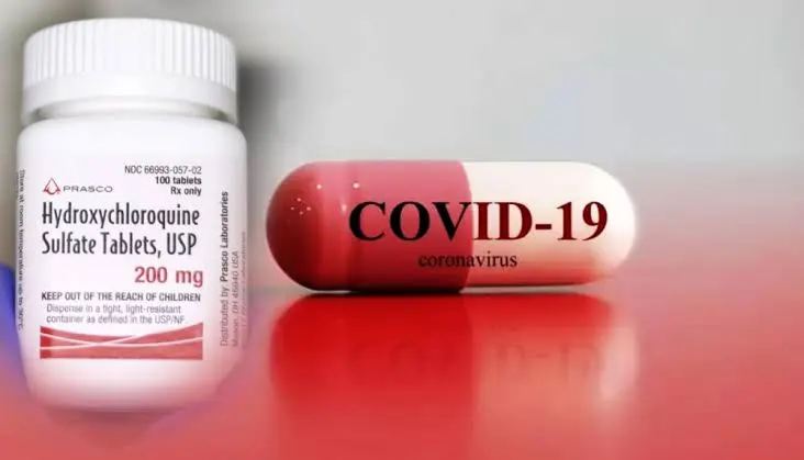 Hydroxychloroquine Sulfate Tablets and COVID-19 capsule on a red surface. Channel i News - চ্যানেল আই নিউজ