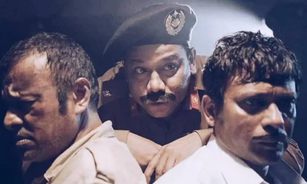 Three men in police uniforms and civilian attire in a tense scene. Channel i News - চ্যানেল আই নিউজ