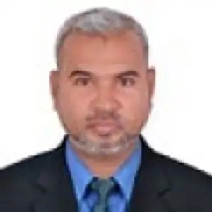 Professional portrait of a middle-aged man with gray hair and beard in formal attire. Channel i News - চ্যানেল আই নিউজ