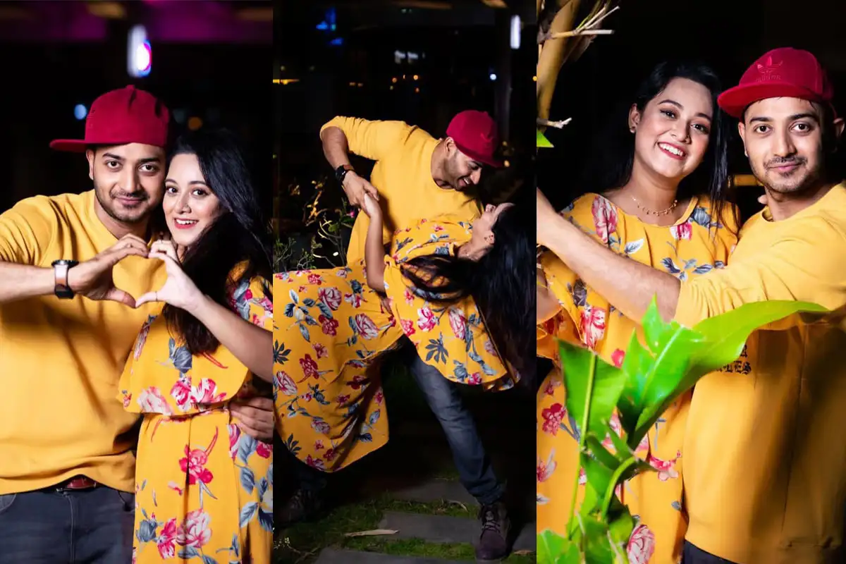Joyful couple celebrating with love and dance at night in vibrant yellow outfits. Channel i News - চ্যানেল আই নিউজ