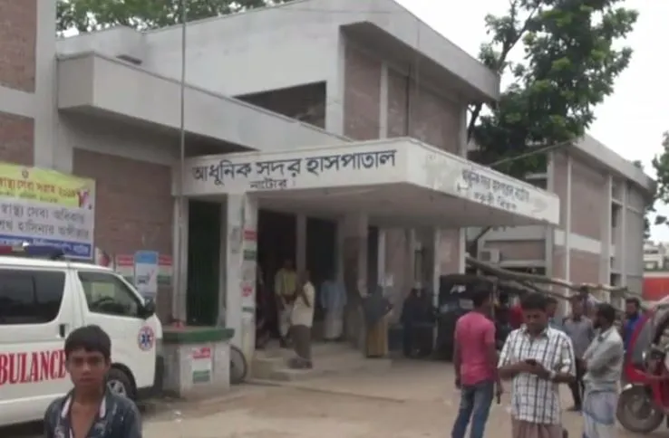 Dhaka Homoeopathic Hospital entrance with people and vehicles outside. Channel i News - চ্যানেল আই নিউজ