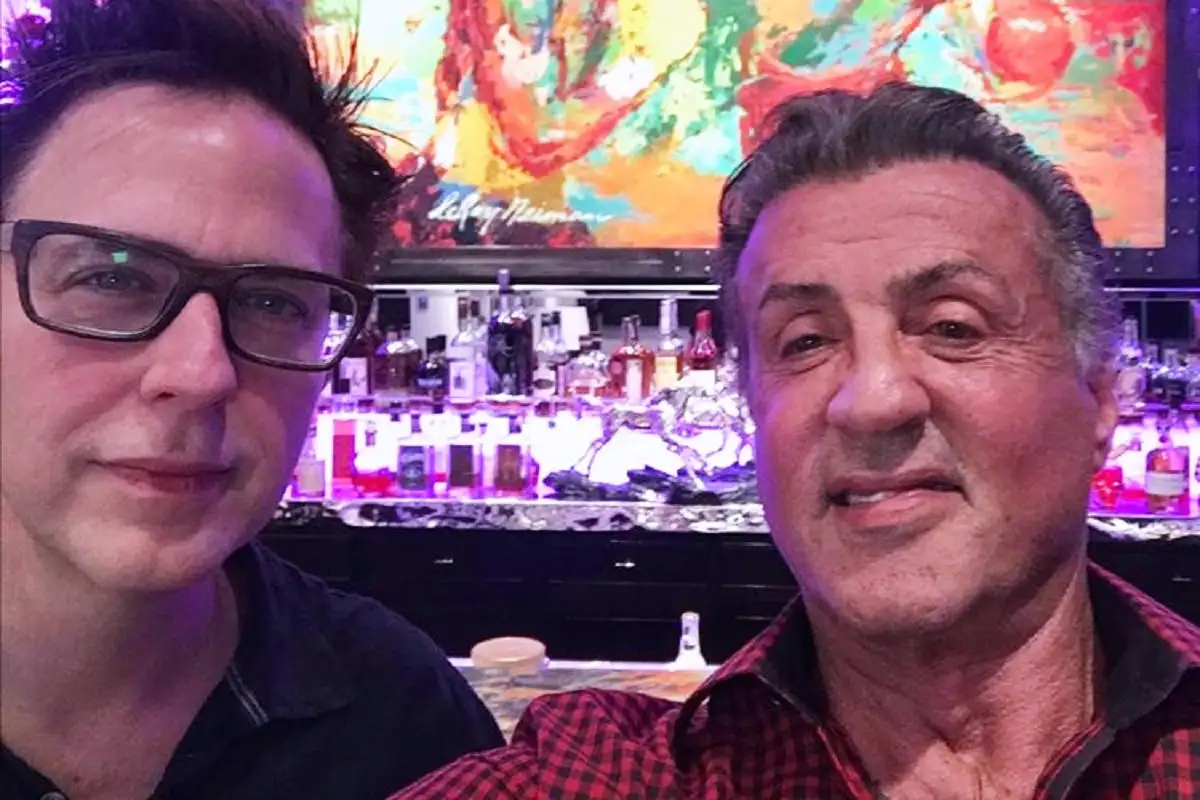 Two men taking a selfie in a colorful, lively bar setting. Channel i News - চ্যানেল আই নিউজ