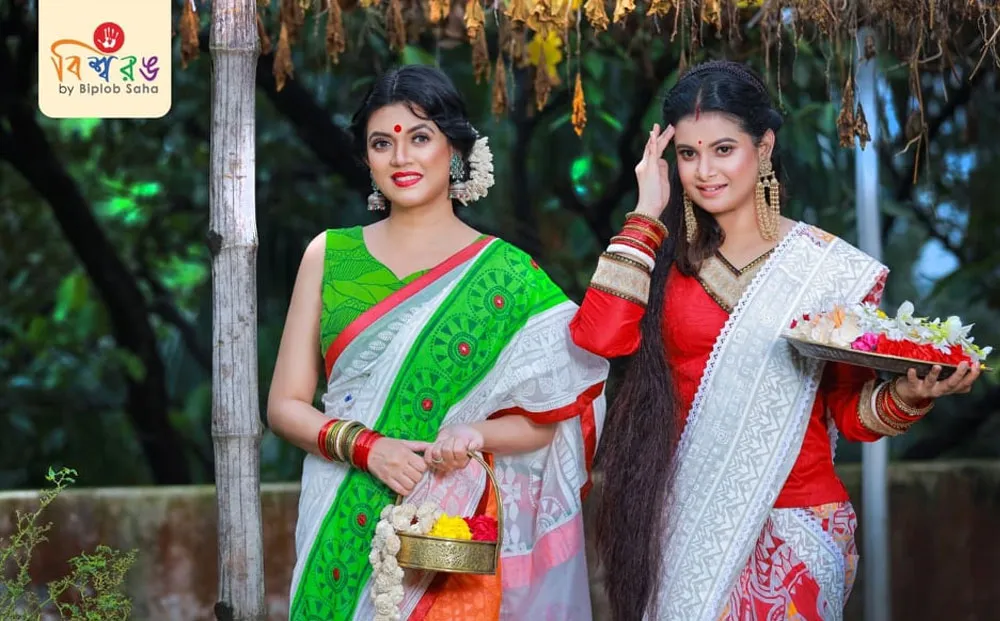 দুটি নারী পোষাক পরা, একে অন্যের পাশে দাঁড়িয়ে, উৎসবমুখর পরিবেশে. Channel i News - চ্যানেল আই নিউজ