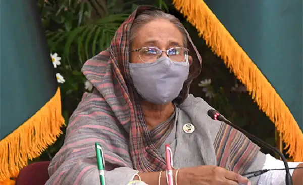 প্রধানমন্ত্রী শেখ হাসিনা মুখে মাস্ক পরে বক্তব্য দিচ্ছেন. Channel i News - চ্যানেল আই নিউজ