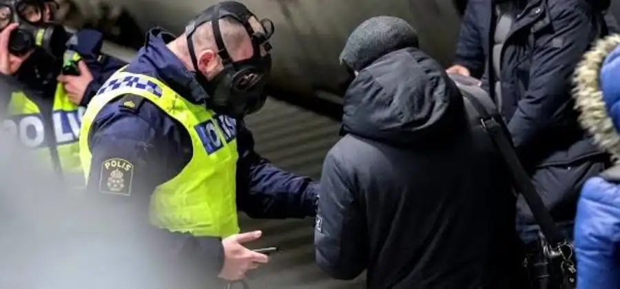 Canadian police officers detain a person at an airport or public place. Channel i News - চ্যানেল আই নিউজ