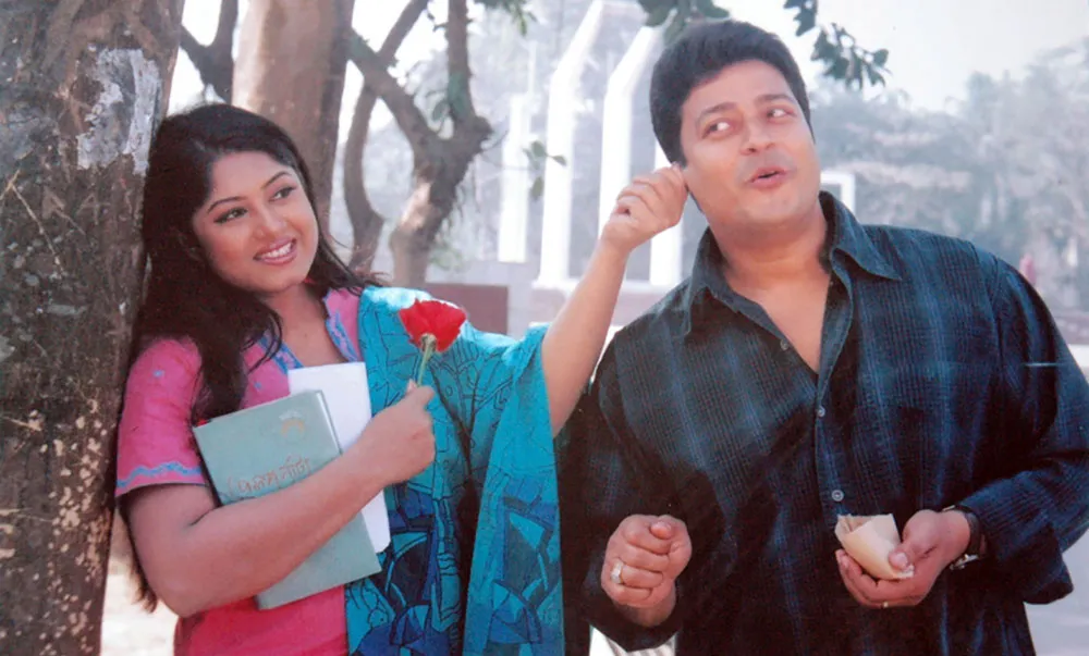 বিনোদনমূলক দৃশ্য যেখানে দুই অভিনেতা হাসিমুখে কথা বলছেন. Channel i News - চ্যানেল আই নিউজ