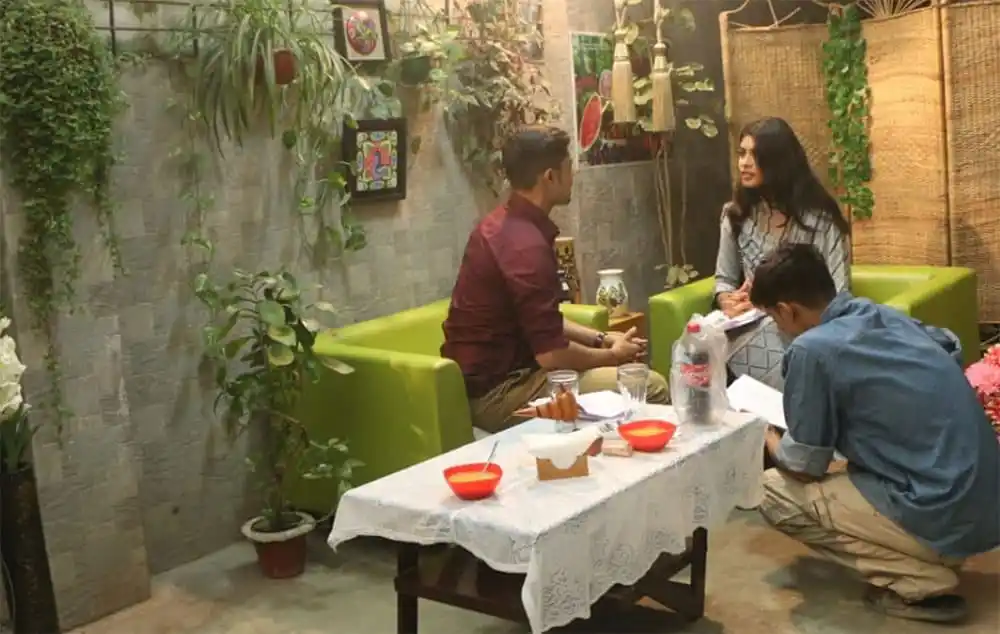 শুটিং হাউজে তিনজন ব্যক্তি আলোচনা করছে, একটি টেবিলের চারপাশে বসে. Channel i News - চ্যানেল আই নিউজ