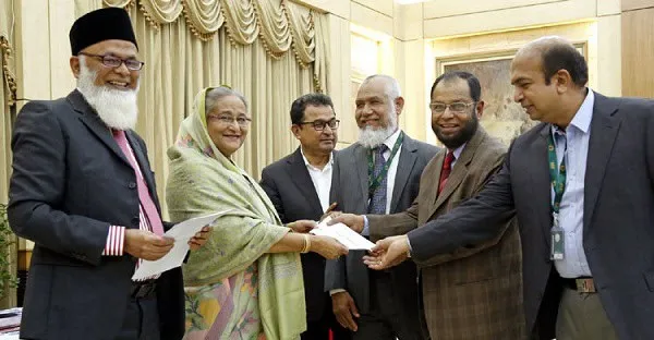 নজরুল ইসলাম মজুমদারসহ অতিথিরা মুদ্রা বিনিময় করছেন. Channel i News - চ্যানেল আই নিউজ