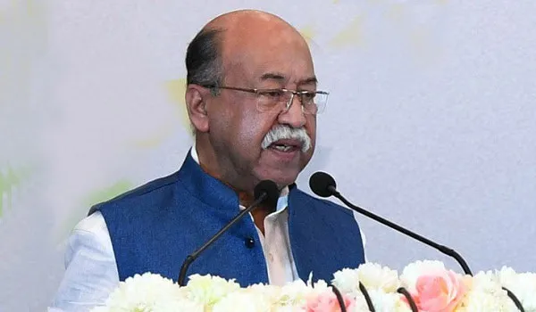 শিল্পমন্ত্রী বক্তৃতা দিচ্ছেন, পেছনে ফুলের সাজানো ব্যাকড্রপ।. Channel i News - চ্যানেল আই নিউজ