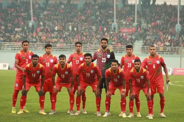 Bangladeshi football team in red jerseys on the field before a match. Channel i News - চ্যানেল আই নিউজ
