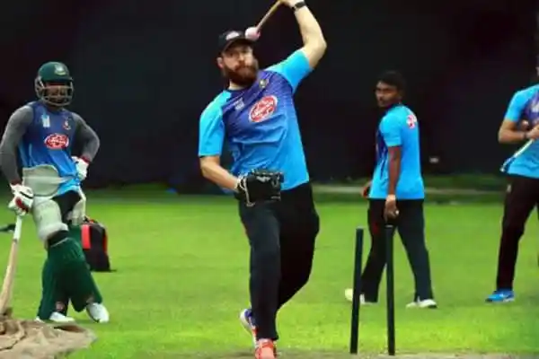 Cricketer in blue jersey practicing batting on the field. Channel i News - চ্যানেল আই নিউজ