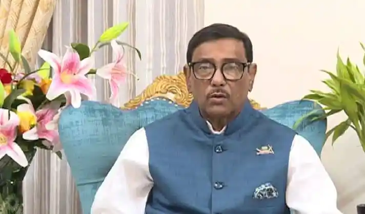 বাংলাদেশের একজন সরকারী কর্মকর্তা বা নেতা, বসার চেয়ারে বসে ভাষণ দিচ্ছেন।. Channel i News - চ্যানেল আই নিউজ