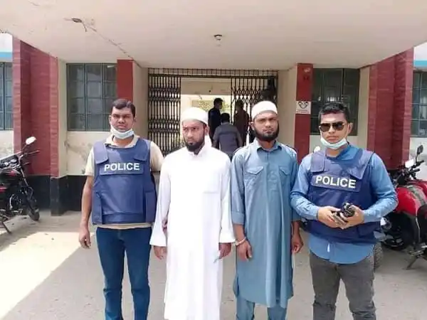 Policemen and a man in traditional attire outside a building in Bangladesh. Channel i News - চ্যানেল আই নিউজ