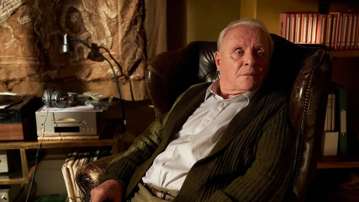 Older man sitting in a leather chair in a cozy, dimly lit room. Channel i News - চ্যানেল আই নিউজ