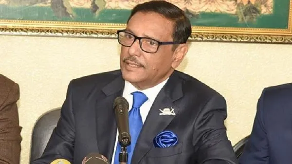 ওবায়দুল কাদের speaking at a formal event in a suit and tie. Channel i News - চ্যানেল আই নিউজ