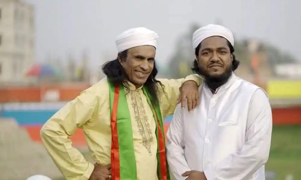দুই ব্যক্তি পরস্পরকে গালে হাত দিয়ে শুভেচ্ছা জানাচ্ছেন. Channel i News - চ্যানেল আই নিউজ