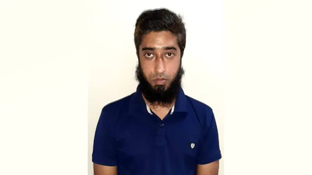 Portrait of a young man with a beard wearing a blue shirt. Channel i News - চ্যানেল আই নিউজ