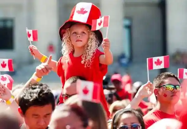 Canadian flag celebration with children during Canada Day event in Bangladesh. Channel i News - চ্যানেল আই নিউজ