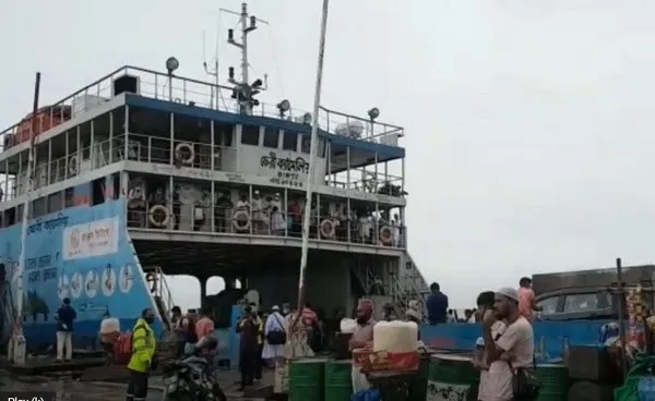 Ferry at the dock with passengers and vehicles during daytime. Channel i News - চ্যানেল আই নিউজ