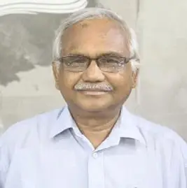 বয়স্ক ব্যক্তি হাসিমুখে, চশমা পরা, হালকা পাজামা পরিহিত. Channel i News - চ্যানেল আই নিউজ