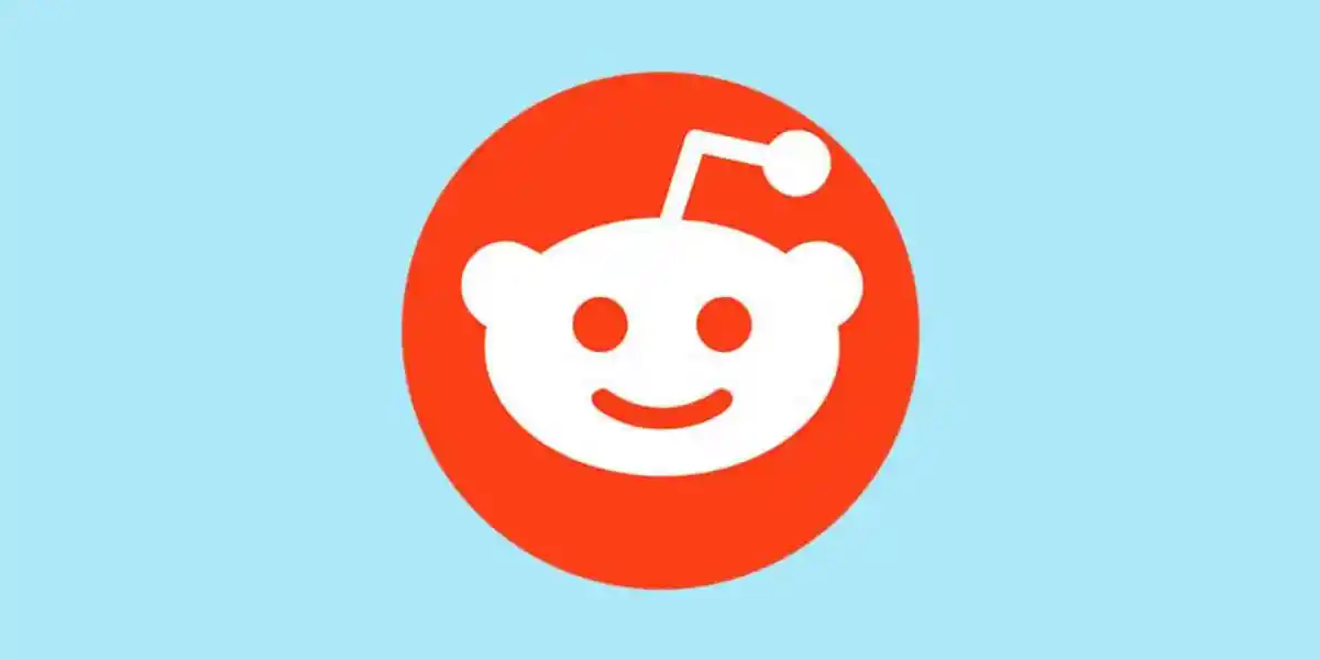 Reddit alien mascot logo on orange background, representing social media platform Reddit. Channel i News - চ্যানেল আই নিউজ