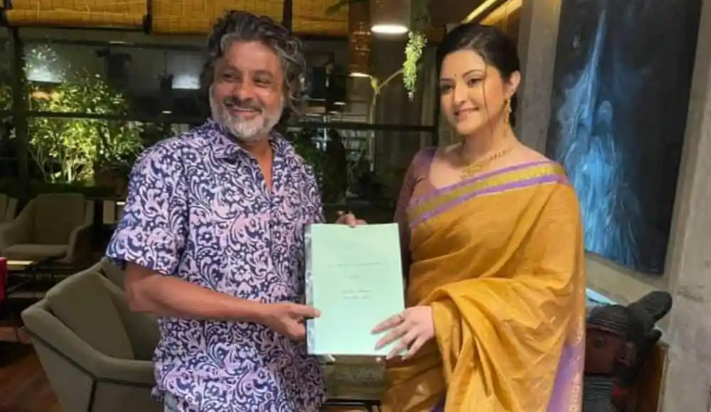 দুই ব্যক্তি সাক্ষাৎকারে বসে, একটি ডকুমেন্ট দেখাচ্ছেন. Channel i News - চ্যানেল আই নিউজ