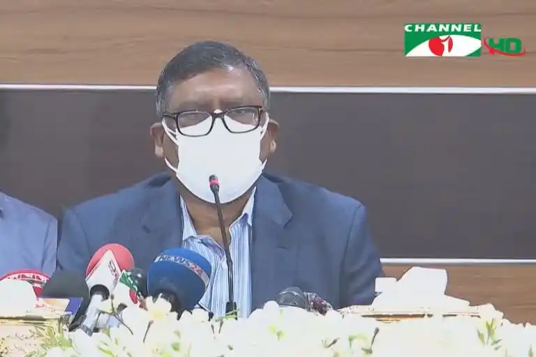 Bangladeshi official wearing glasses and face mask at press conference. Channel i News - চ্যানেল আই নিউজ