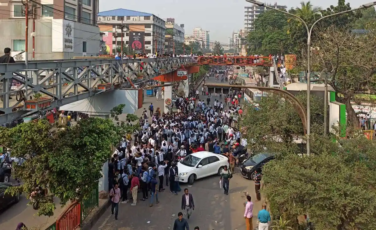 Bangladesh commuters gather on a busy street near a metro rail station. Channel i News - চ্যানেল আই নিউজ