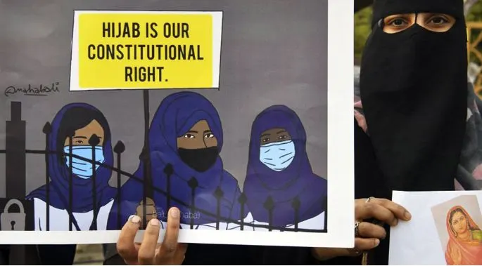 Protesters with hijab and masks hold signs demanding constitutional rights. Channel i News - চ্যানেল আই নিউজ