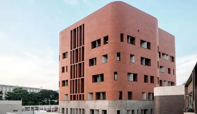 Modern red brick building with unique window design in Bangkok. Channel i News - চ্যানেল আই নিউজ