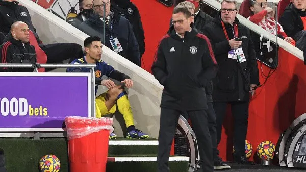 Manchester United players and staff on the bench during a match. Channel i News - চ্যানেল আই নিউজ
