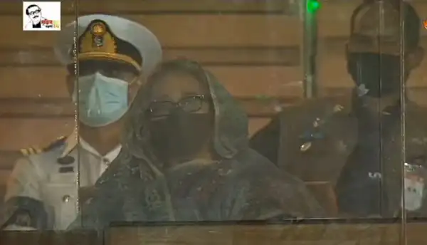 Bangladeshi woman wearing a mask and glasses at a public event. Channel i News - চ্যানেল আই নিউজ