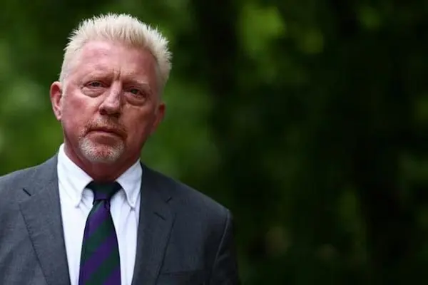 A man with blond hair and a beard wearing a suit outdoors. Channel i News - চ্যানেল আই নিউজ
