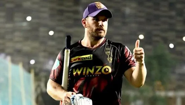 Cricketer in black and red jersey giving thumbs up on field. Channel i News - চ্যানেল আই নিউজ