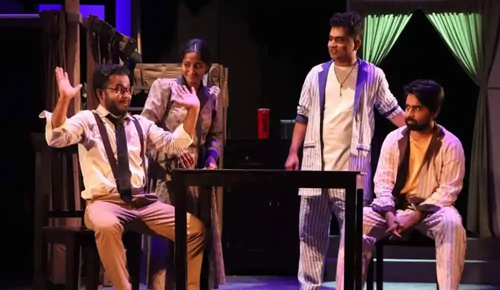 নাটকের দৃশ্যে অভিনেতারা অভিনয় করছেন, মঞ্চে আলো ও প্রোডাকশন সেট সহ. Channel i News - চ্যানেল আই নিউজ