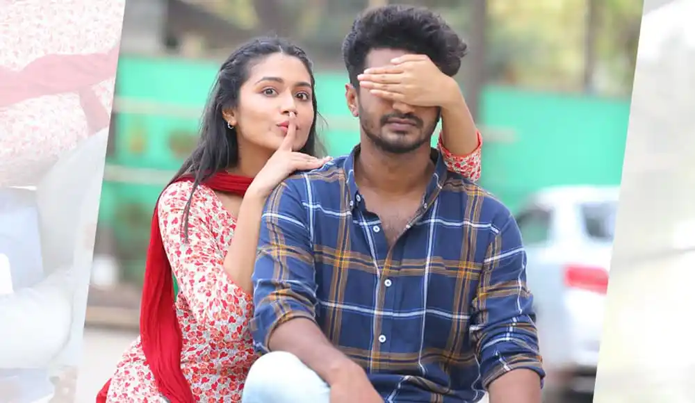 একজন নারী তার চোখ ঢেকে থাকা পুরুষের মুখে চুম্বন করছে. Channel i News - চ্যানেল আই নিউজ