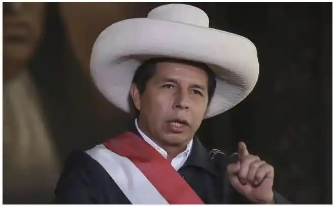 Peruvian politician wearing a large white hat and speaking at a press conference. Channel i News - চ্যানেল আই নিউজ