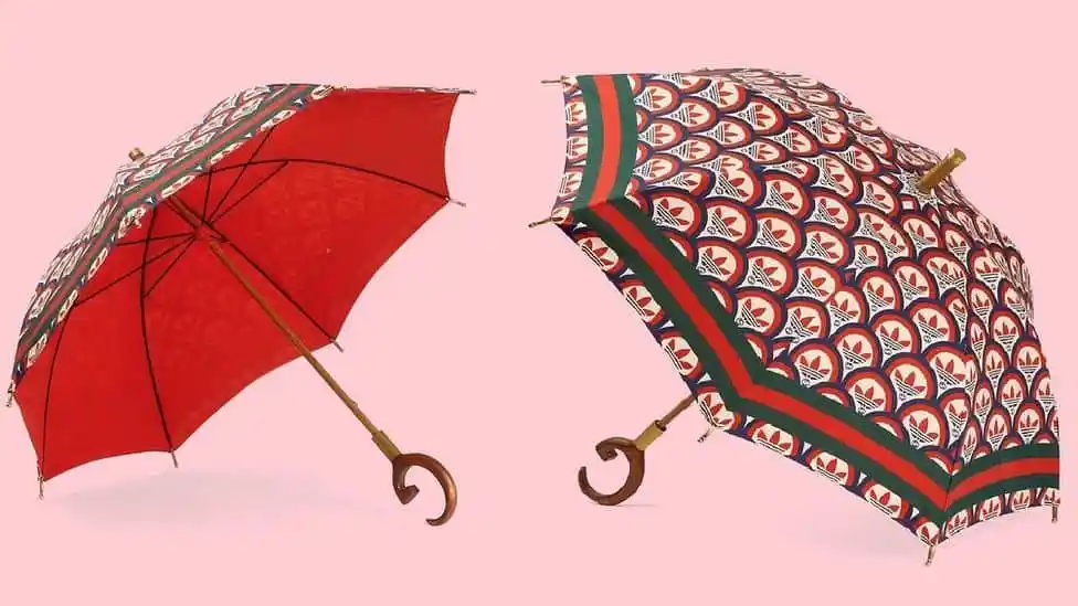 দুটি রঙিন ছাতা, একটিতে লাল ও অন্যটিতে প্যাটার্ন, উভয়ই খোলা অবস্থায়।. Channel i News - চ্যানেল আই নিউজ